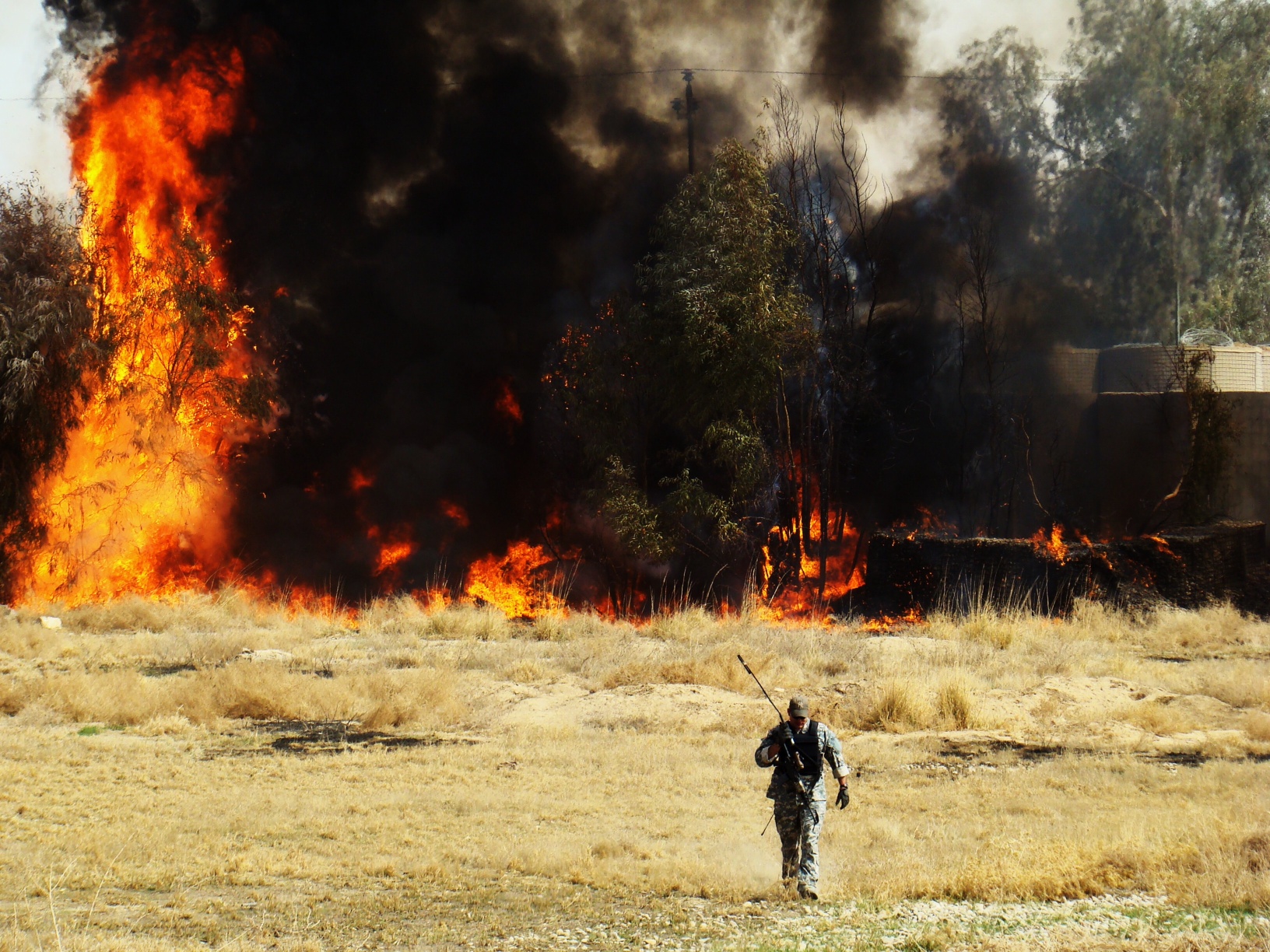 soldier walking away from big explosion 